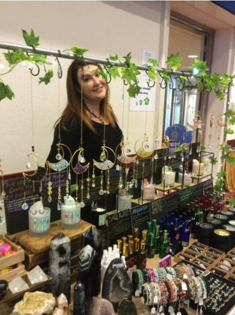 An exhibitor at her crystal stall